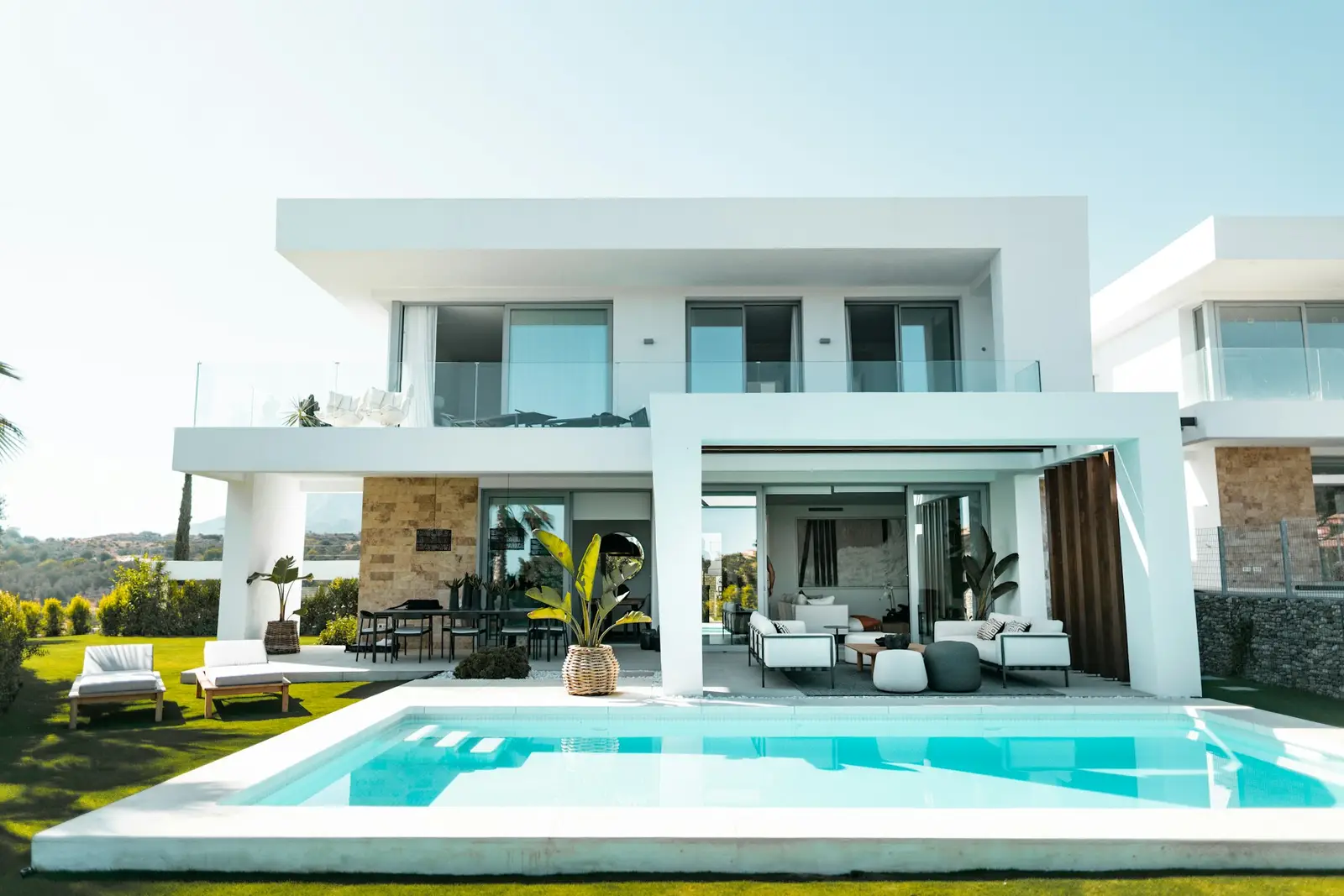 Two-story house with a pool and white facades