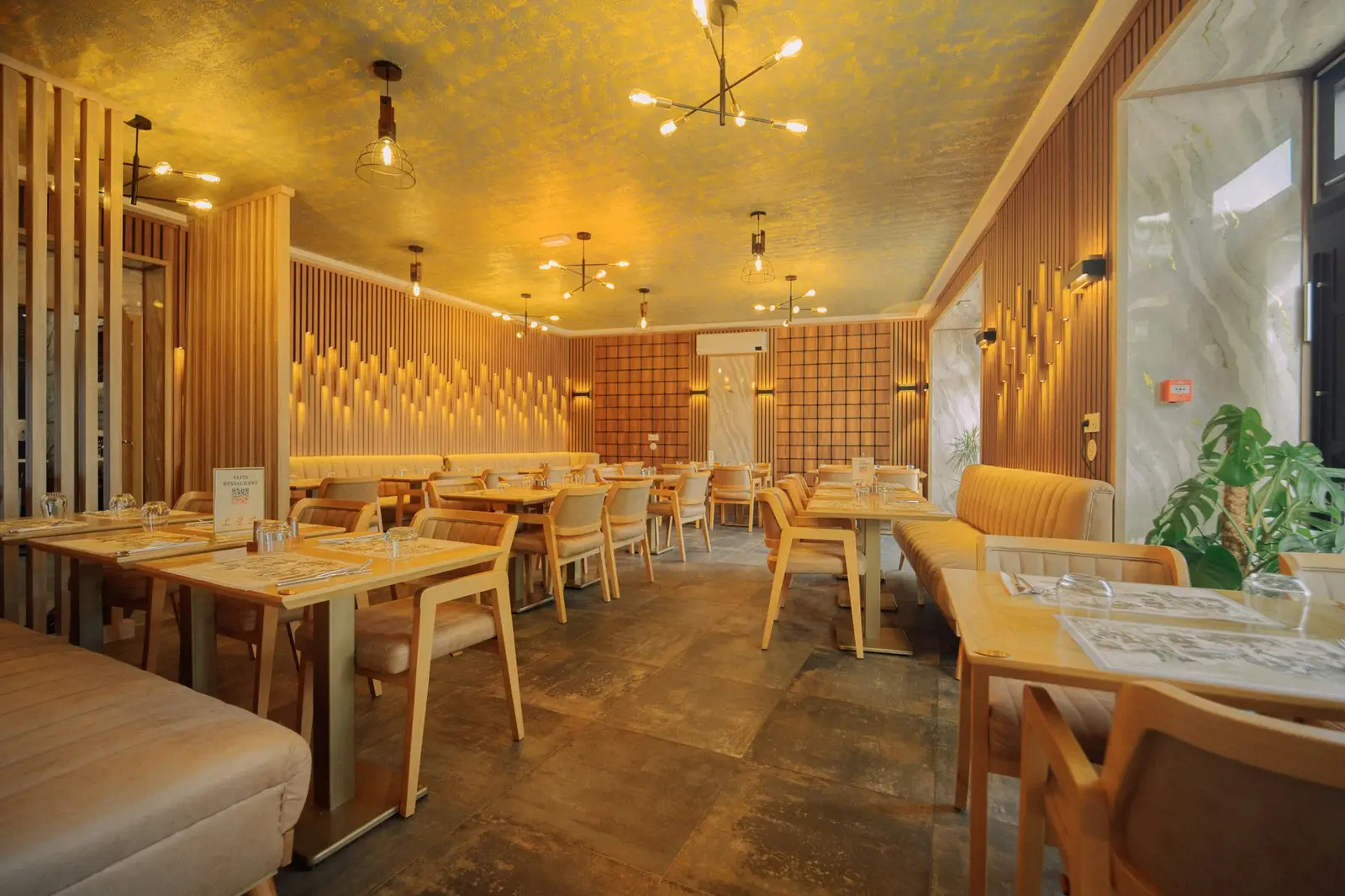 Restaurant dining room with warm lighting and wood seating
