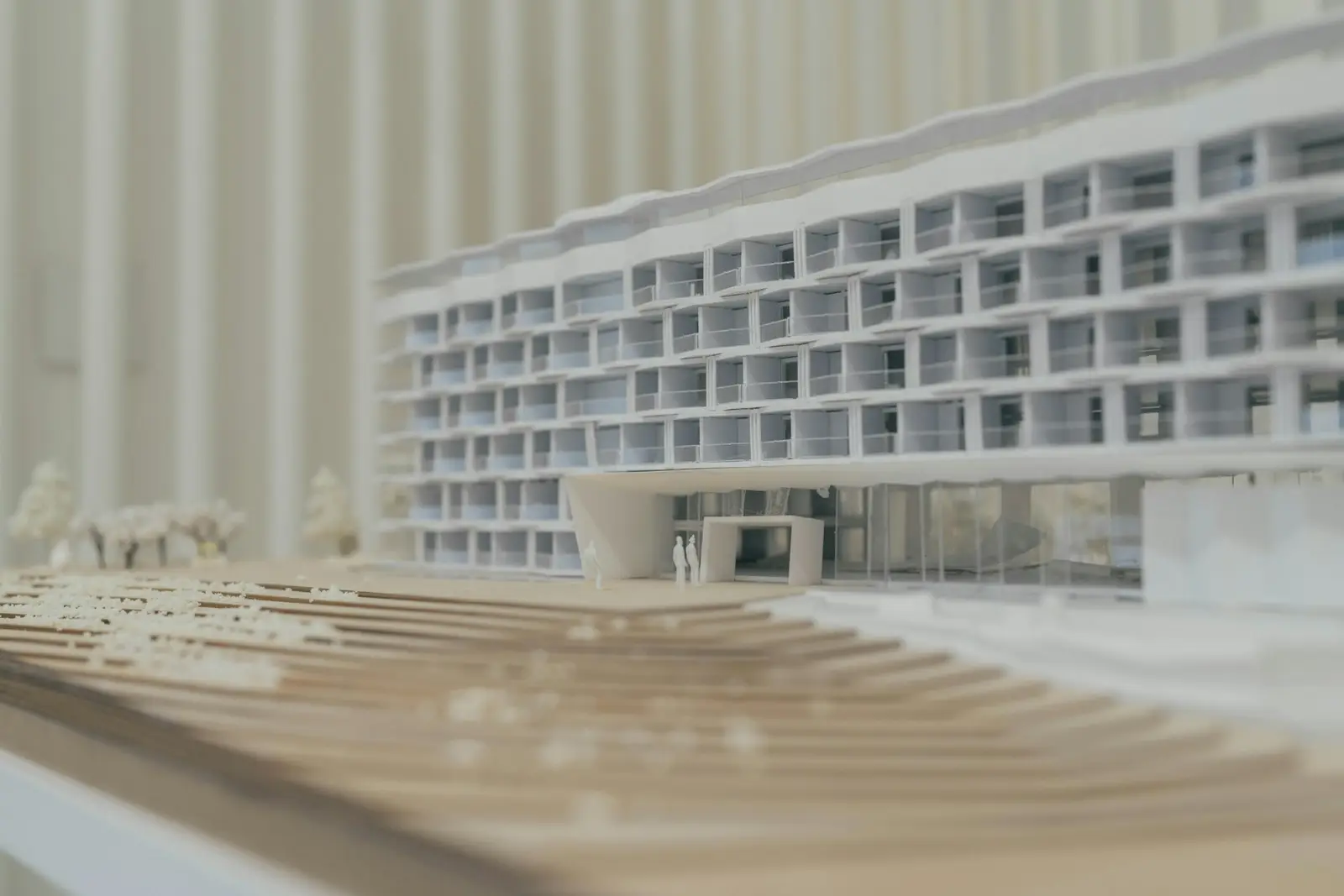 White cardboard model of a multistory residential building with balconies